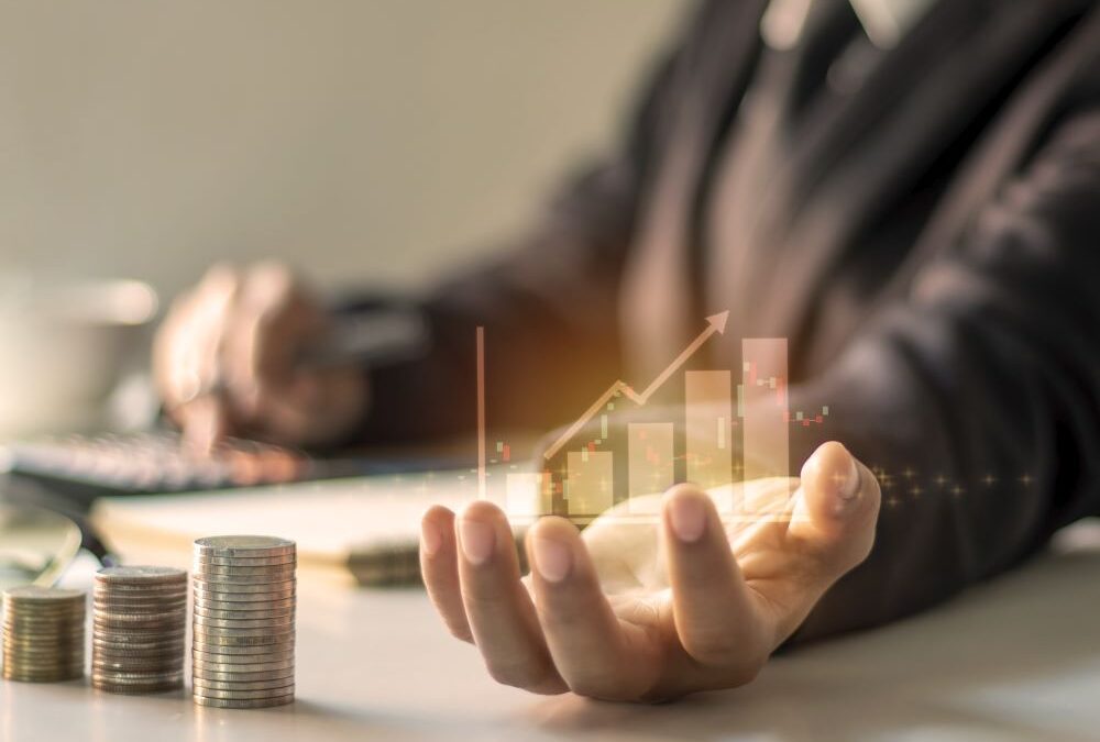 A person in a suit holds a holographic bar chart with an upward arrow, symbolizing growth, while stacks of coins and a calculator in the background highlight the importance of choosing the right franchise.